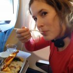Veronika eating airplane food.