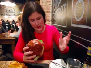 Veronika enjoining her burger, while I did a fatal mistake and took a burger with pancakes instead of bread buns. :(