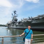 Me in front of aircraft carrier