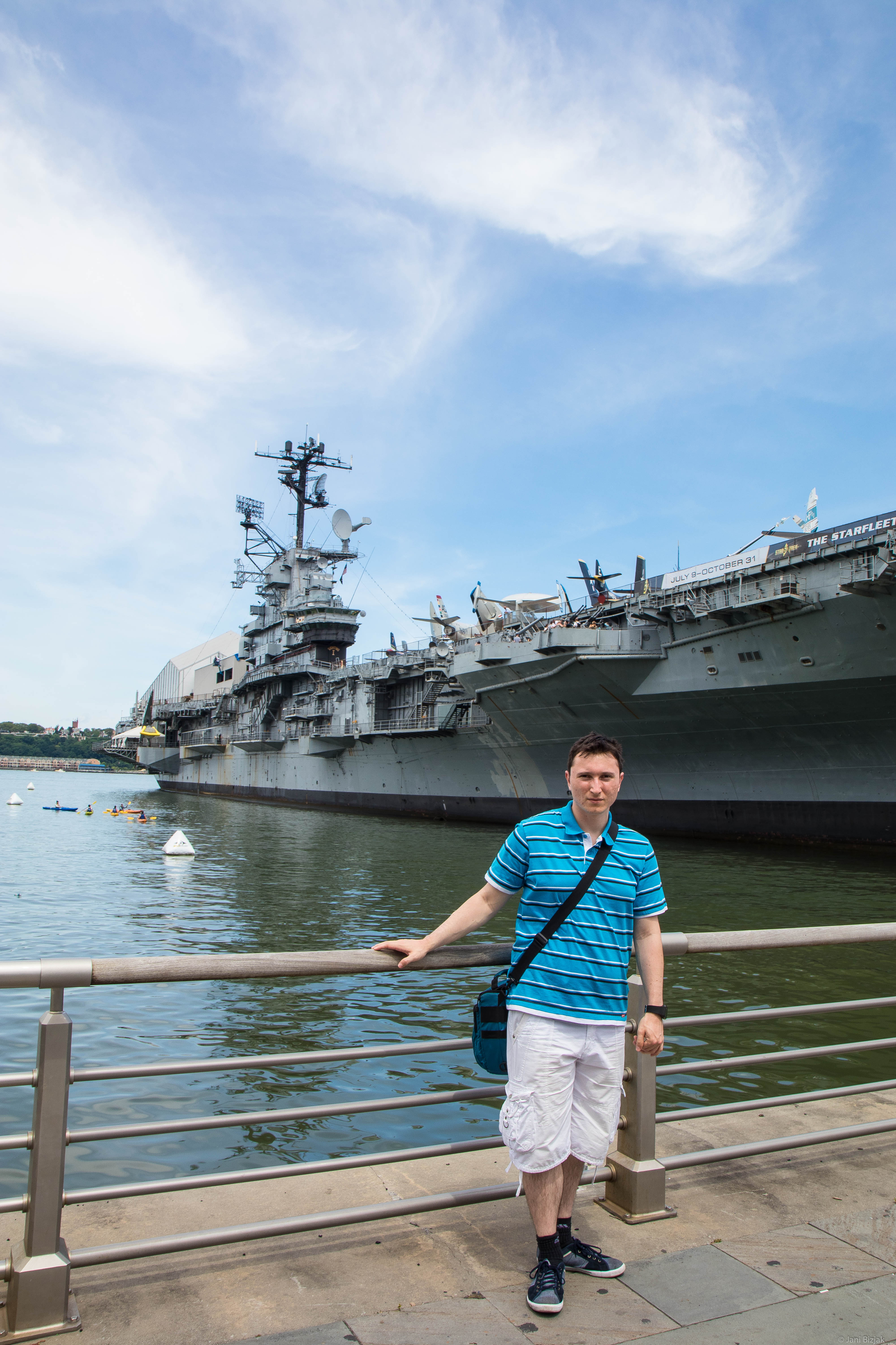 Me in front of aircraft carrier