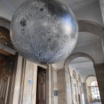 Gigantic moon in front of a museum.